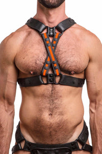 Front-on shot of defined model wearing an ARMY OF MEN black and fluro orange leather chest harness with matte black hardware.