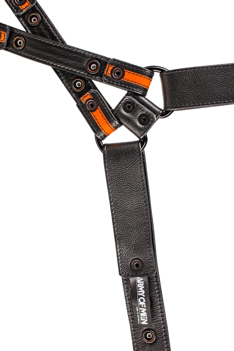 ARMY OF MEN black and neon orange leather chest harness with matt black hardware, laid flat and showing the lining.