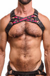 Toned male model in an ARMY OF MEN UNIVERSAL X HARNESS - Fluro Pink with matte black hardware. Front straps crossed.