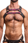 A hairy model wearing a UNIVERSAL X HARNESS - Fluro Pink with black rivets, snaps, and D-rings. Front straps parallel.