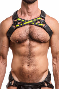 A front facing model in an ARMY OF MEN UNIVERSAL X HARNESS - Fluro Yellow with matt black hardware. Front straps crossed.