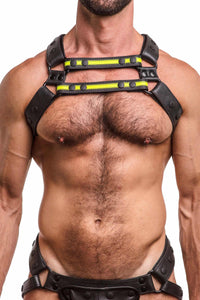 ARMY OF MEN UNIVERSAL X HARNESS - Fluro Yellow with matte black D-rings styled on a hairy model. Front straps parallel.