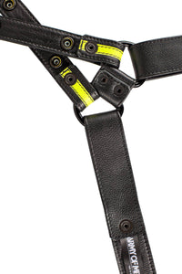 ARMY OF MEN UNIVERSAL X HARNESS - Fluro Yellow with matte black rivets, snaps, and D-rings, laid flat showing the lining.