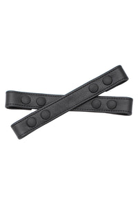 A 1" wide ARMY OF MEN UNIVERSAL X STRAPS - Black with matte black snaps, laid flat and viewed from above.