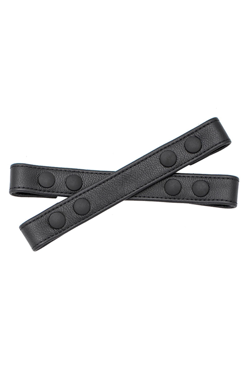 A 1" wide ARMY OF MEN UNIVERSAL X STRAPS - Black with matte black snaps, laid flat and viewed from above.
