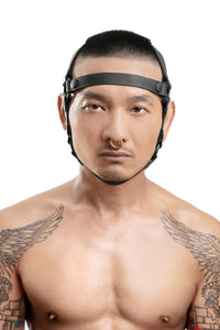 Front-on shot of Asian model wearing a unique ARMY OF MEN HEAD HARNESS BASE - Black with matte black snaps.