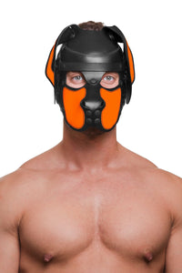 Shot from the chest up, the toned model is wearing a handcrafted leather pup hood, with fluorescent orange ears and snout.