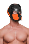 Angled slightly with his shoulders turned, the model wears a black veg tan leather pup hood, with neon orange ears and snout.