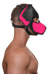 With his naked torso facing sideways, the model wears a handmade leather pup hood, with fluorescent pink ears and snout.