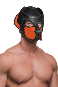 A shirtless male model in playful black veg tan leather ARMY OF MEN pup hood, with orange snout and ears. Three-quarter pose.