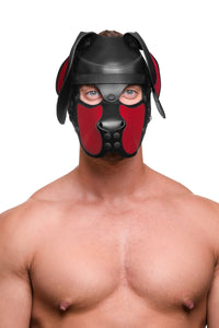 Framed from the chest up, a model in an Australian made leather pup hood with red snout and ears, looking straight forward.