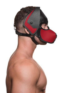 A side-profile of a fit model in a black and red leather ARMY OF MEN pup hood, with matte black O-rings, snaps and rivets.