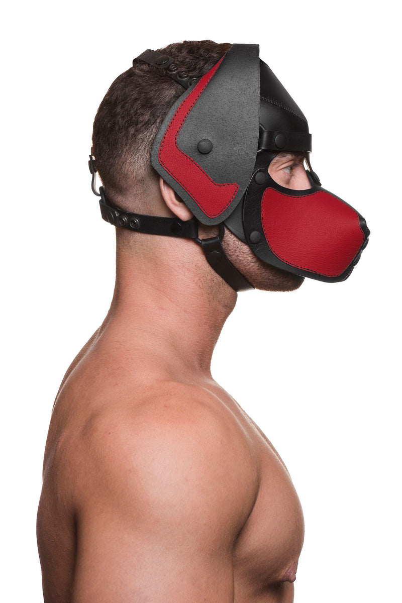 A side-profile of a fit model in a black and red leather ARMY OF MEN pup hood, with matte black O-rings, snaps and rivets.