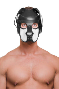 Muscular model posing in a black and white leather ARMY OF MEN pup hood with black metal hardware, staring straight at you.