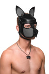 Well-built male model, posed at a slight angle, in a leather pup hood, with grey ears, snout and matte black metal hardware.