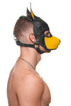 Pictured from the side, a bare-chested male model wears a handmade leather ARMY OF MEN pup hood, with yellow snout and ears.