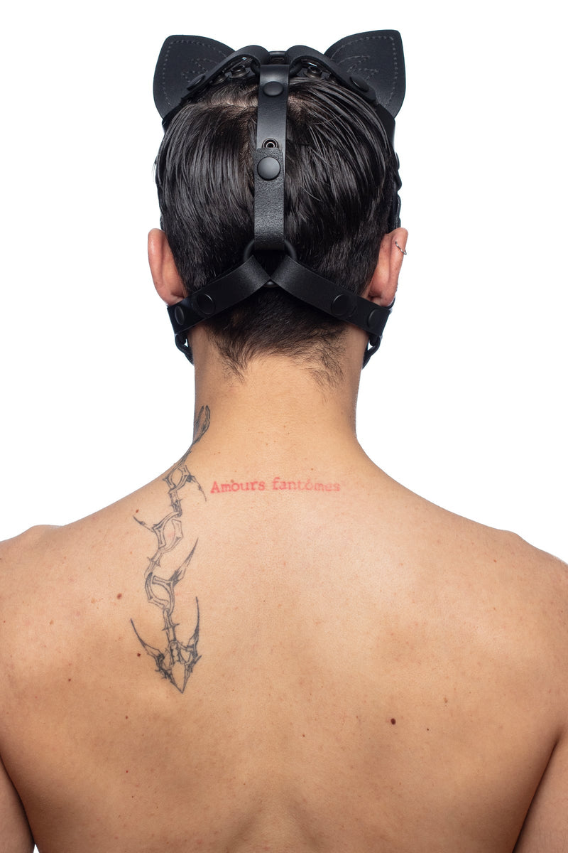 The back view of a model posing in an ARMY OF MEN cat hood, featuring hard-wearing matte black metal rings and snap caps.