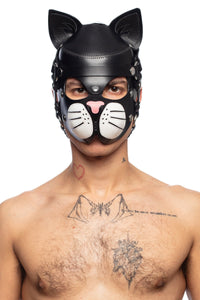 Viewed front on, from the chest up, an attractive man models a black all leather cat hood with stainless steel detailing.