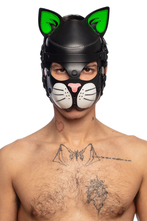 Captured from the chest up, the model facing forward is wearing a cute, all leather cat hood, with fluorescent green ears.