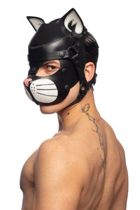 Seductive, shirtless model looking over his shoulder, dressed only in an ARMY OF MEN black and white leather TOMCAT hood.