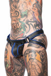 ARMY OF MEN handmade COMBAT JOCK - Blue with matte black O-rings styled on a tattooed model, seen in a three-quarter profile.