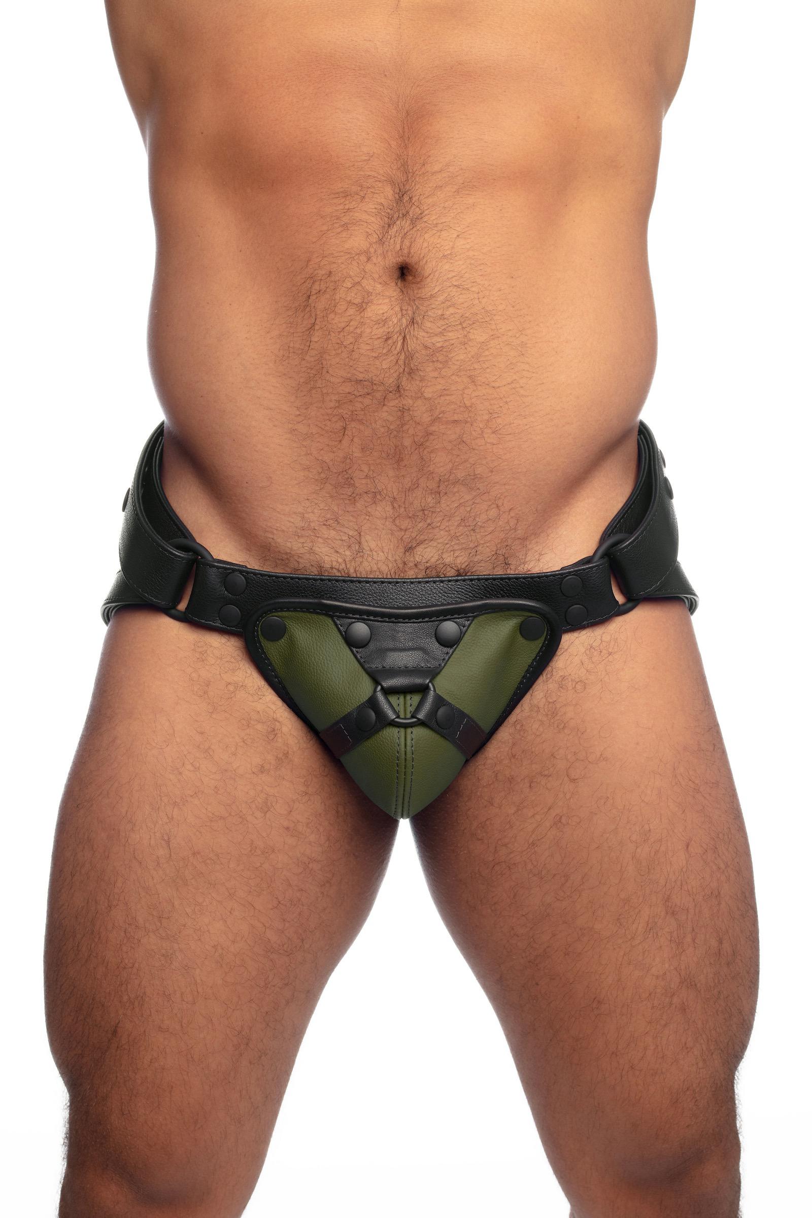 Muscular male model wearing an army green and black leather jockstrap.
