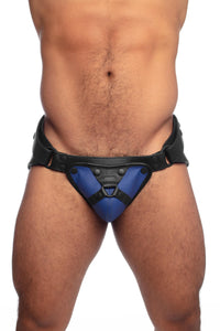 Front view of a model in a black and blue leather jock with harness detailed codpiece.