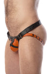 Three-quarter view of male model in a quality ARMY OF MEN HARNESS JOCK 2.0 - Orange with matte black hardware.