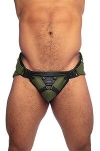 Model in an army green and black leather jockstrap with harness codpiece. Front view.