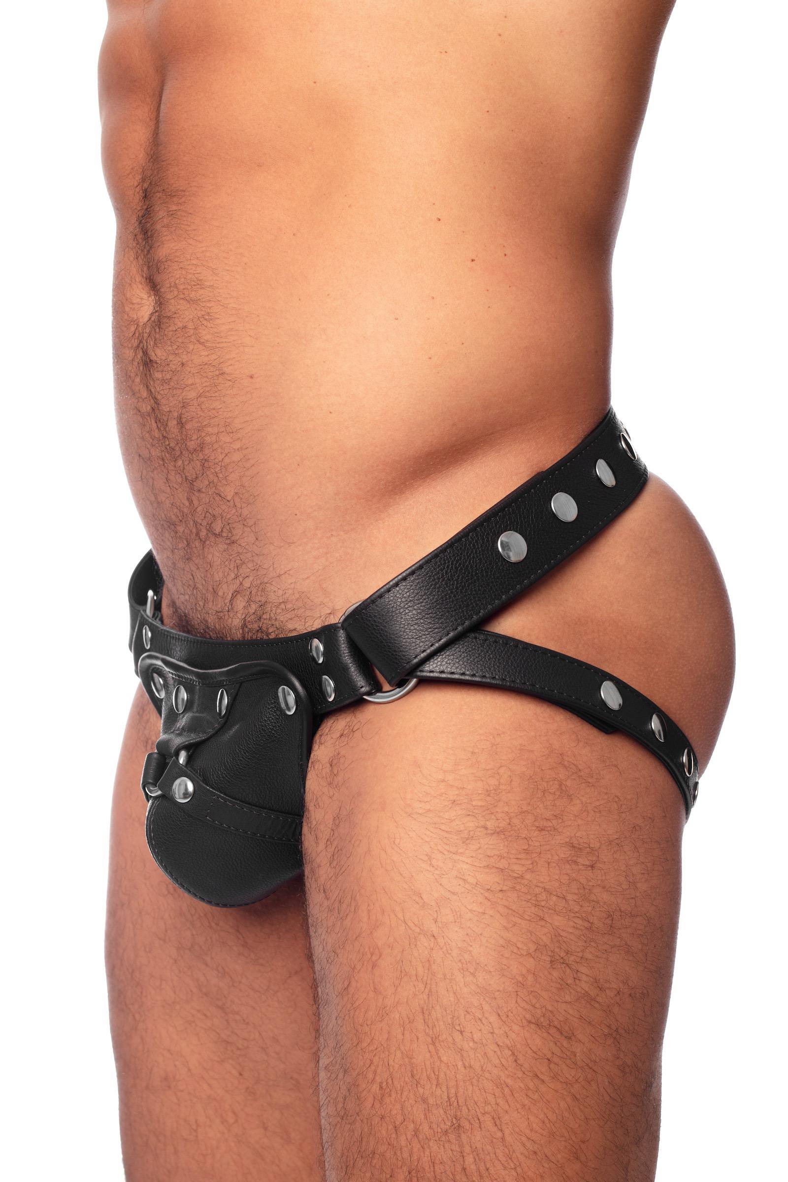 Model wearing a black leather harness jockstrap with stainless steel hardware. Side view.