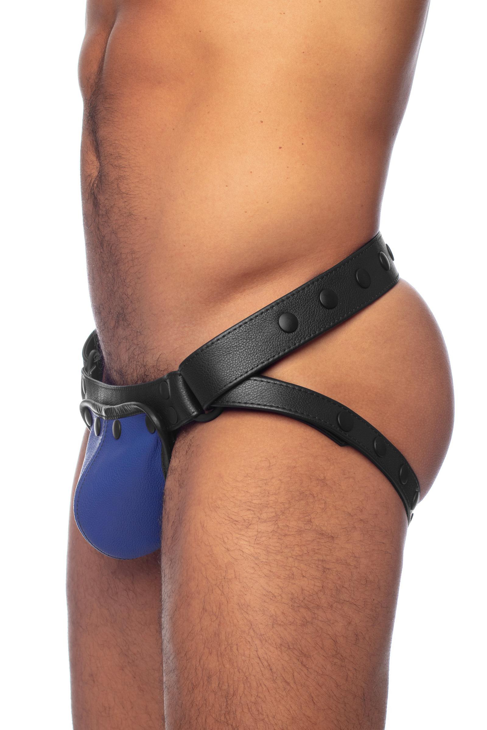 Model wearing black leather jockstrap with blue leather codpiece. Side view.