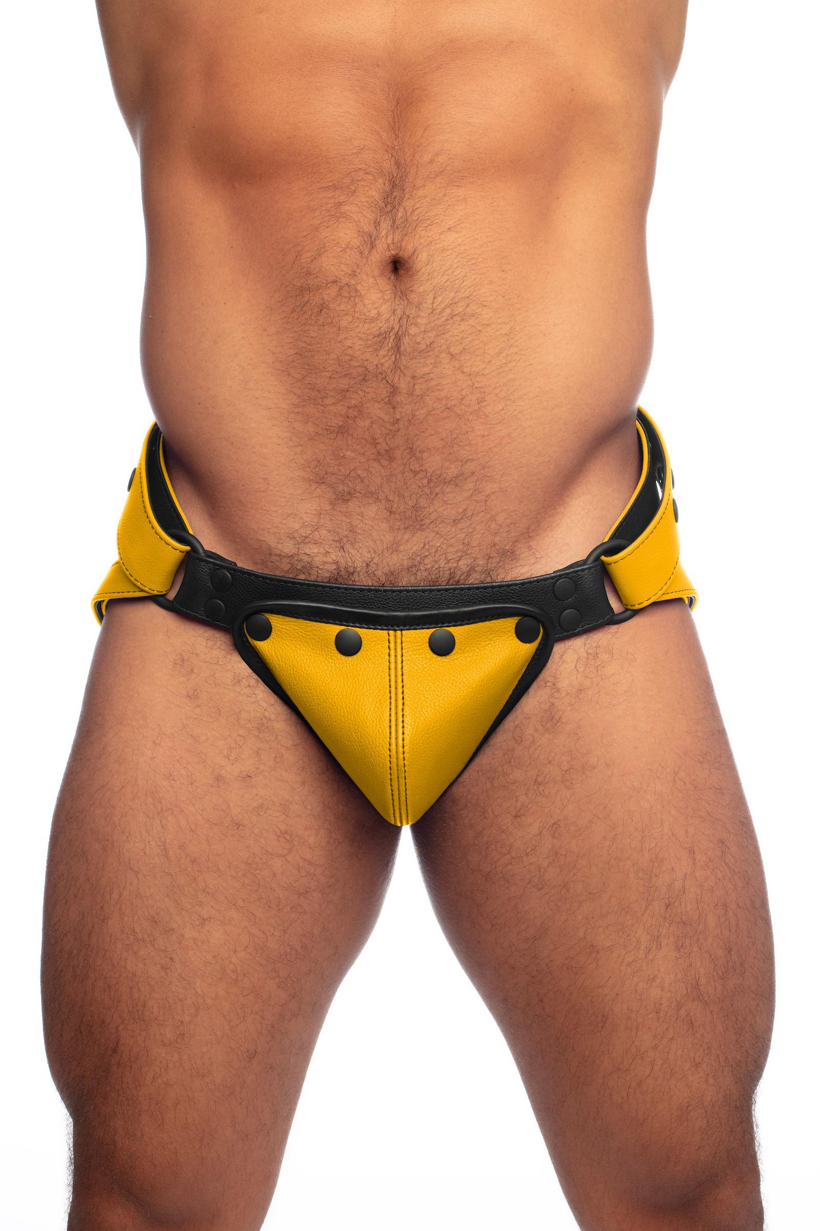 Front view of a model in a yellow leather jockstrap and detachable codpiece.