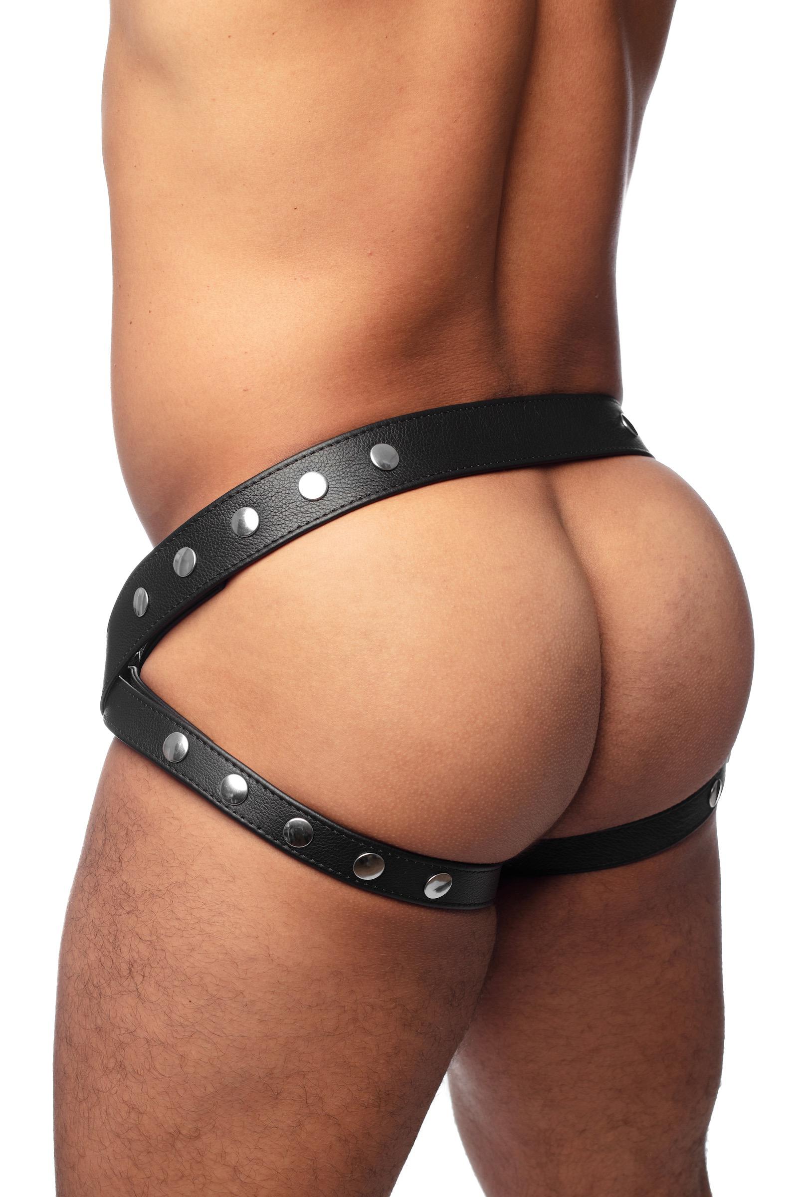 Thick model wearing a black leather jockstrap with stainless steel hardware. Back view.