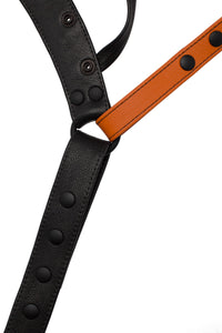 Flat view of front side of a black and orange leather jockstrap