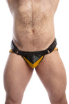 Front view of model wearing a black and yellow leather jockstrap with shadow detail on codpiece