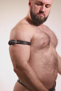 Video of a model wearing a 1" wide black leather armband belt with stainless steel hardware