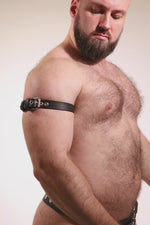 Video of a model wearing a 1" wide black leather armband belt with stainless steel hardware