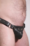 Video of a model wearing a black leather thong with stainless steel hardware and a matching harness codpiece