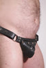Video of a model wearing a black leather thong with stainless steel hardware and a matching harness codpiece