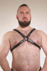 Video of a model wearing a classic leather narrow x harness with stainless steel hardware.