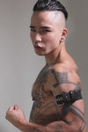 Model wearing a 1.5" black leather combat armband belt with stainless steel hardware