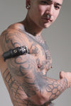 Model wearing a 1" black leather combat armband belt with stainless steel hardware