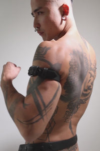 Model wearing a 1" black leather combat armband belt with matt black hardware