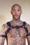 Model wearing black and blue leather combat bulldog harness with matt black metal hardware.