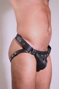 Male model wearing a black leather HARNESS JOCK with stainless steel hardware.