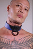 Model removing a 1.5" wide black and blue leather Chevron Collar