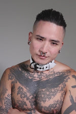 Model wearing 1.5" wide white leather pup collar with matt black buckle and D-ring