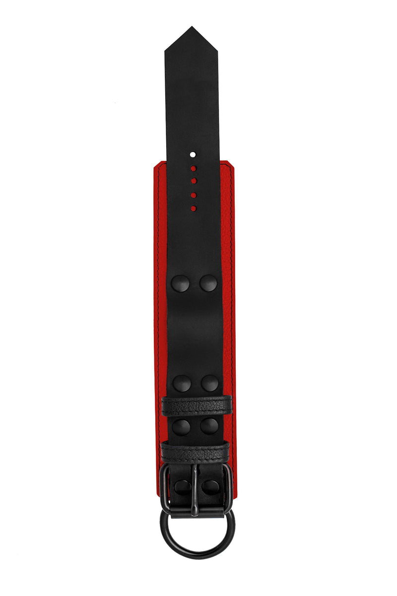 A 2.25" wide ARMY OF MEN WRIST RESTRAINTS - Red with matte black rivets, buckle, and D-ring, laid flat and shot from above.