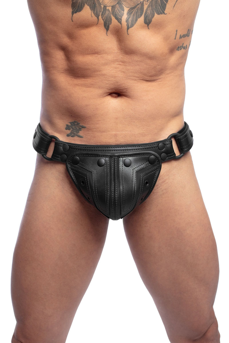 Male model in an Australian made ARMY OF MEN black leather Combat thong with matte black hardware, front facing view.