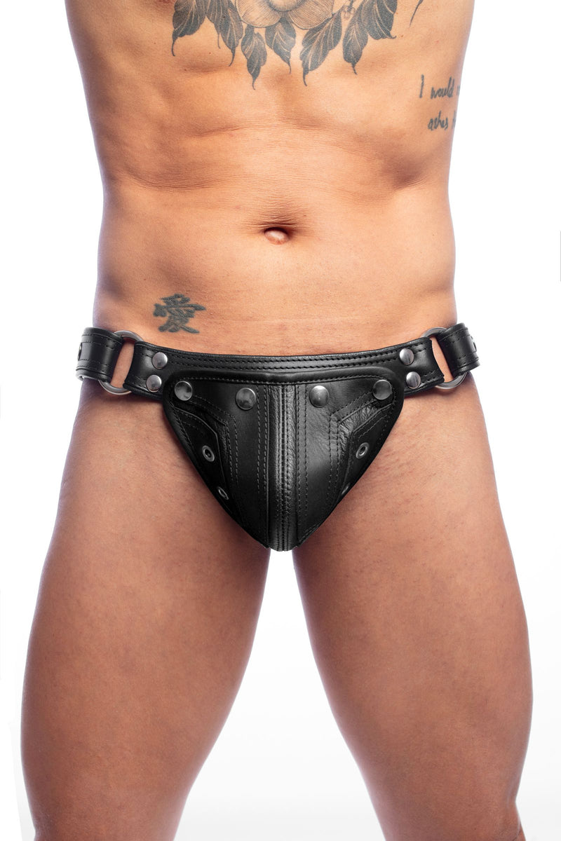 Male model in a leather ARMY OF MEN COMBAT THONG, made with stainless steel rivets, snaps, and O-rings, front facing view.